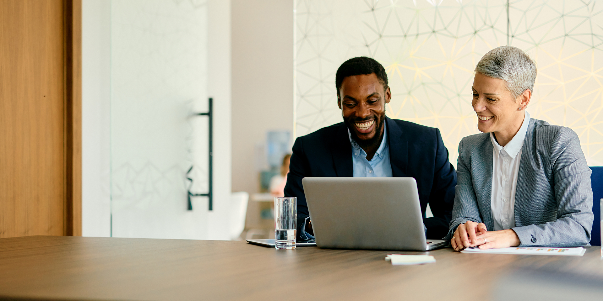 Smiling coworkers collaborating in office setting